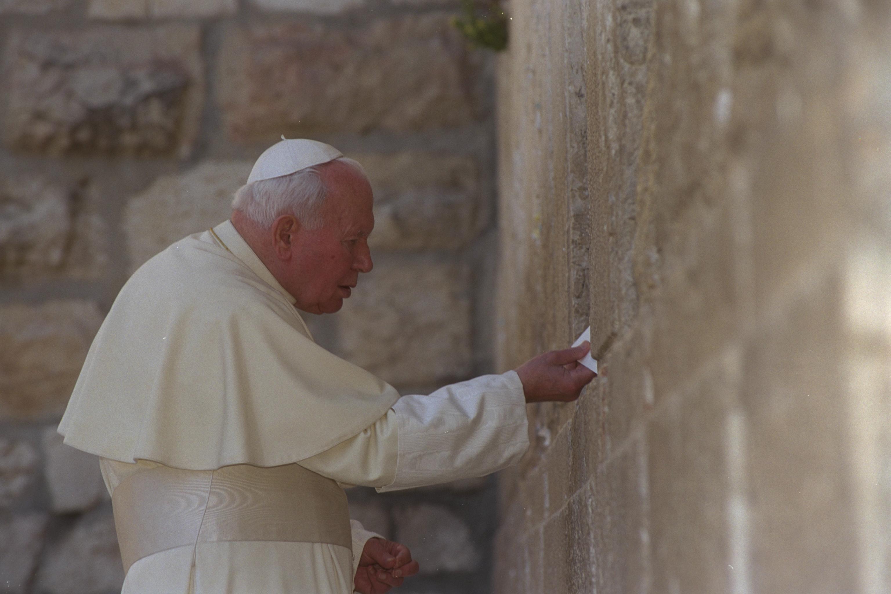 Pope John Paul II placing his prayer at the Western Wall, Jerusalem, 2000